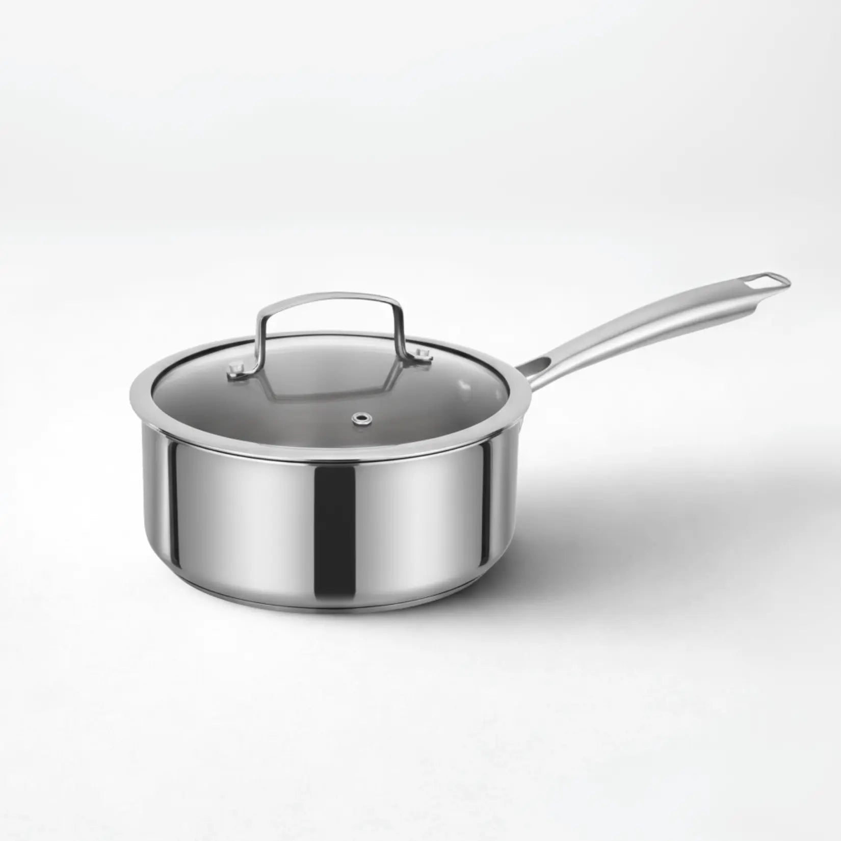 Polished titanium sauce pan with glass lid and long handle, minimalist lightweight cookware for everyday cooking